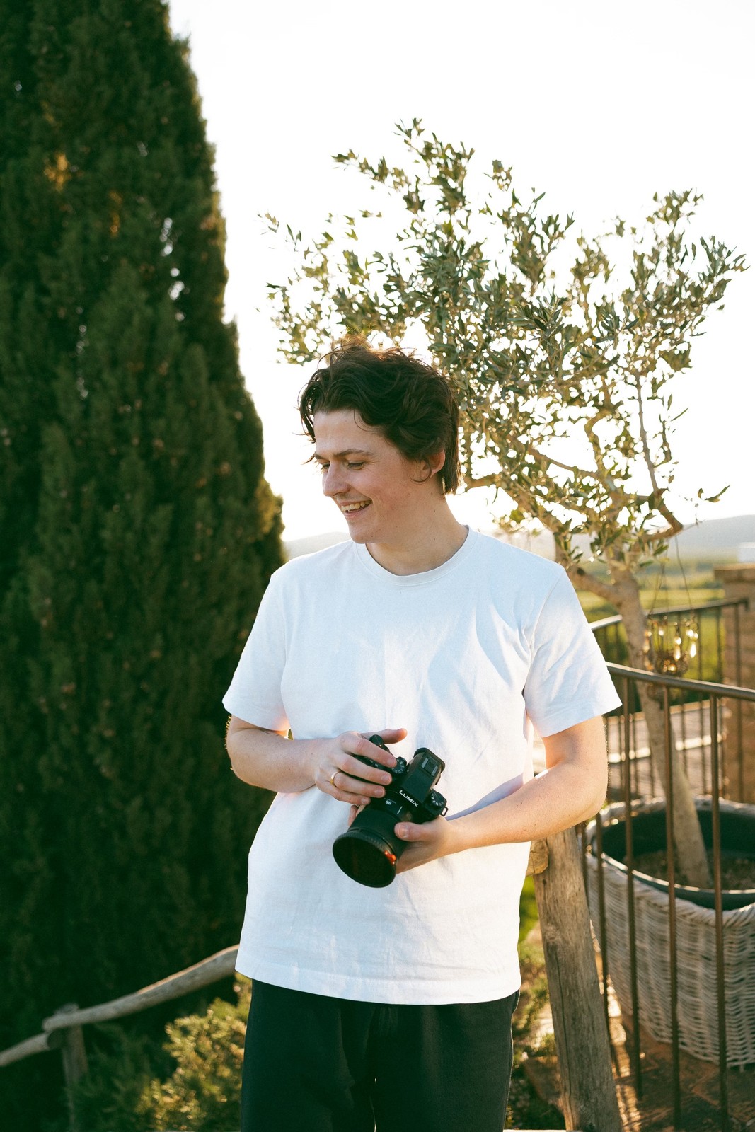 George Hughes holding his camera at golden hour