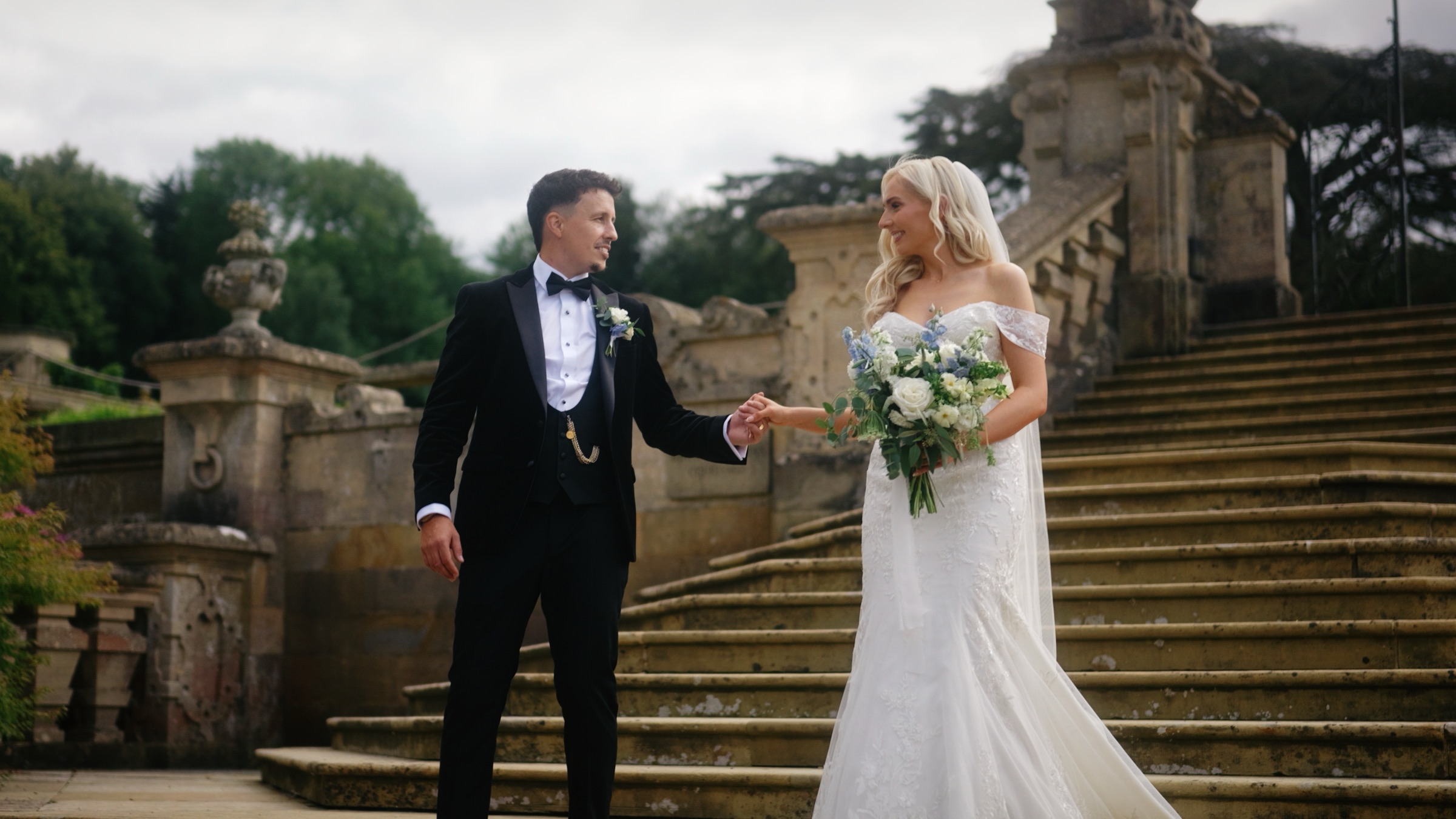 Sarah and Scott on the grand stone steps at Harlaxton Manor