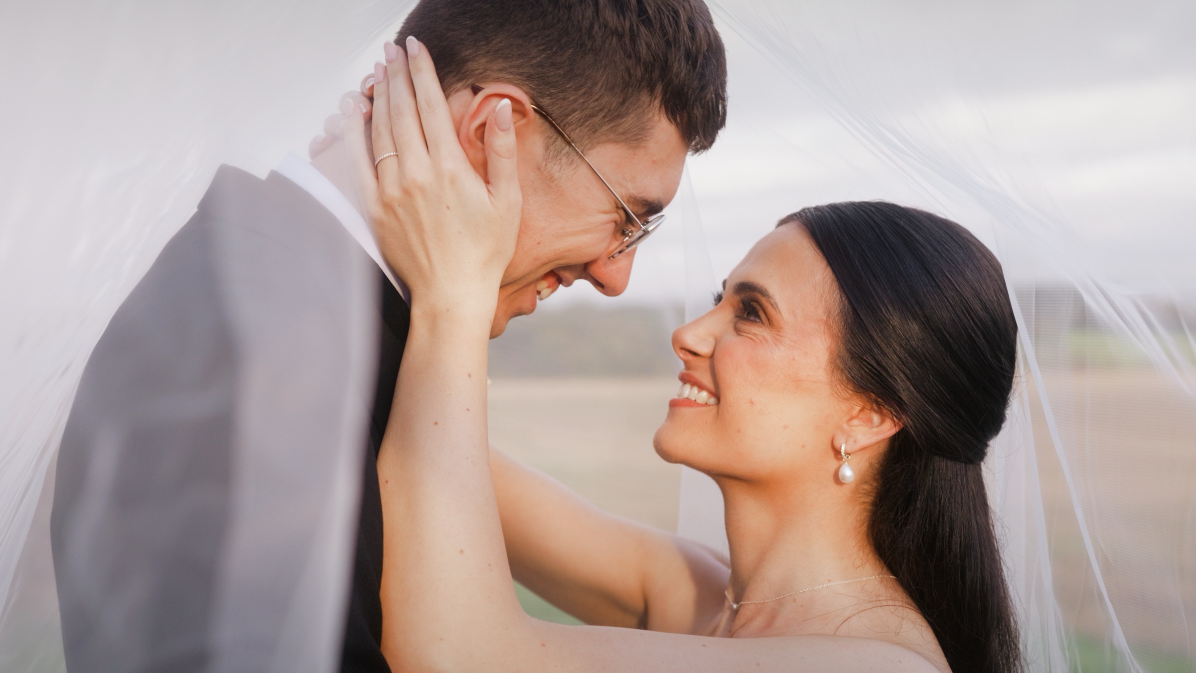 Rebekah and Benjamin under her veil at Swancar Farm, Nottinghamshire